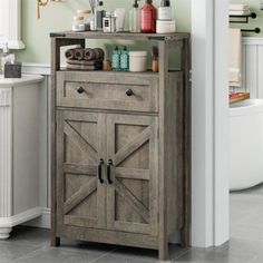 a bathroom cabinet with doors and drawers in the middle of it, next to a sink