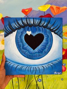 a painting of an eye with a heart in the center, surrounded by poppies