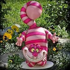 an inflatable pink and white striped animal sitting on top of a table next to flowers