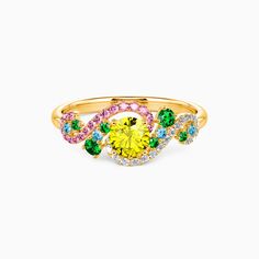 a yellow ring with multicolored stones on it