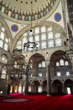 the inside of a large building with chandeliers hanging from it's ceiling