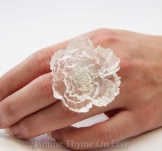 Big Statement Ring, Resin Flower Ring, Flower Ring, Rose Ring, Big White Ring, Flower Jewelry, Statement Jewelry, Resin Ring, Bridesmaid Jewelry This ring is pure glam and not someone who wants to fade into the woodwork, but if you like to make a statement it is for you! You chose the color! The flower is two inches across. If you would like the matching bangle show in the last picture please click the link below. https://www.etsy.com/ca/listing/480778248/flower-bracelet-cuff-bracelet-white?ref= Big Statement Rings, Ring Resin, Ring Flower, Special Necklace, Jewelry Resin, Rose Ring, Satin Flowers, Statement Ring Silver, Resin Ring