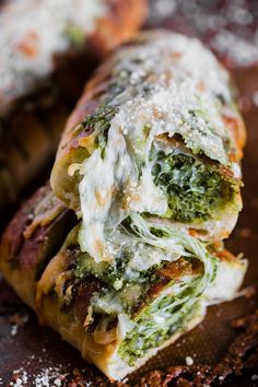 some food that is sitting on top of a wooden table and covered in white sauce