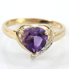 14k Yellow Gold Amethyst Heart & Diamond Ring This Cute 14k Amethyst Heart & Diamond Ring Would Make A Perfect Gift. The Heart Shaped Setting Houses A Heart Shaped Amethyst With 8 Accenting Diamonds. The Main Stone Is A Bit Abraded, But Nothing Detrimental And Very Difficult To See With The Naked Eye. This Ring Can Be Resized By Any Qualified Jeweler. Size: 8 (Resizable) Metal: 14 Karat Yellow Gold Weight 2.10dwt // 3.27 Grams Stone: Heart-Cut Amethyst & Diamond Melee Stones 814958-1 * D-Dcx Heart Shaped Amethyst, Heart Diamond Ring, Amethyst Heart, Diamond Heart Ring, Heart Diamond, Stone Heart, Diamond Heart, Womens Jewelry Rings, Purple Gold