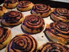 many cinnamon rolls on a baking sheet ready to be baked