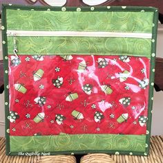 a red and green piece of cloth sitting on top of a chair