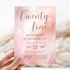 a person holding up a pink card with the words twenty fine on it in front of a fluffy white background