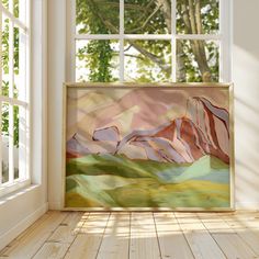 a painting hanging on the wall in front of a window with sunlight streaming through it