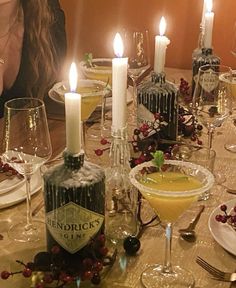 a woman sitting at a table with wine glasses and candles