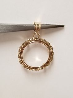 "Thanks for shopping our vintage estate store. We tend to sell well below wholesale and truly hope you enjoy all of our items. Many of the items are one of a kind, so please enjoy scrolling through the pictures and hopefully something will catch your eye. Spots are from reflection or camera. Estate 14k yellow gold bezel holder 1/10-coin rope twist pendant. Works great with any 1/10 gold coins. Length: 1 1/8\" Diam: 3/4\" Weight: 1.51 grams Bail: 3mm Nice 14k coin bezel pendant." Classic Gold Jewelry With Bezel Setting, Classic Filigree Round Pendant Jewelry, Collectible Yellow Gold Round Cut Jewelry, Collectible Round Cut Yellow Gold Jewelry, Yellow Gold Jewelry With Bezel Setting Round Pendant, 14k Gold Pendant With Bezel Setting, Heirloom Yellow Gold Jewelry With Bezel Setting, Classic 14k Gold Necklaces With Bail, Ornate Yellow Gold Round Pendant Jewelry