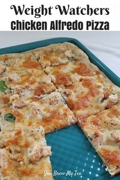 chicken alfredo pizza cut into squares on a blue tray with text overlay that reads weight watchers chicken alfredo pizza