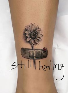 a woman's foot with a sunflower and knife on it