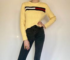 "Product Details: Gorgeous vintage pastel light yellow ribbed pullover by Tommy Hilfiger. Long sleeve and ribbed, this cozy sweater is perfect for every occasion. Has TH logo across chest of sweater. Pair it with black jeans. Has stretch. Brand: Tommy Hilfiger Material: 100% Cotton Marked Size: L Measurements: Waist: 18.5\" Length: 22\" Neck Drop: 2.5\" Amazing condition. Model: 5'9\" All sales are final." Th Logo, Tommy Hilfiger Long Sleeve, Pullover Outfit, Pullover Sweater Women, Pastel Yellow, Cozy Sweater, Ribbed Sweater, Cozy Sweaters, Light Yellow