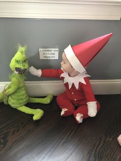 two stuffed animals sitting next to each other on a wooden floor in front of a wall