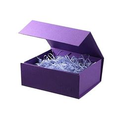 an open purple box filled with shredded paper