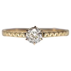 a yellow gold engagement ring with an old cut diamond