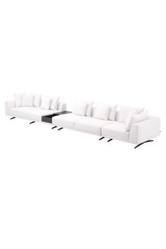 three white couches sitting next to each other