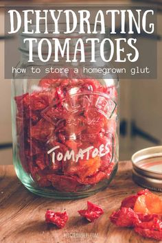 a jar full of tomatoes sitting on top of a wooden table with the title, dehydrating tomatoes how to store a homegrown glut