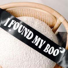 a bamboo basket filled with white towels and a black ribbon that says i found my boo