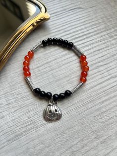 🎃 Halloween Bracelet 🎃  Orange and black 6mm glass beads with silver accents.  SIZE: S/M  🖤JEWELRY CARE: Avoid direct contact with lotions, perfumes and soap or other chemicals that could cause discoloration.  🧡TIPS: Remove before showering, swimming, or other water activities. ⚠️ WARNING: Bracelets are made with small beads that could be a choking hazard.  - Do not leave children unattended with jewelry. - Excessive stretching can lead to breaking/ tearing the bracelets Halloween Black Bracelets With Round Beads, Black Round Bead Bracelets For Halloween, Black Stretch Bracelet With Round Beads For Halloween, Black Round Beaded Bracelets For Halloween, Black Beaded Bracelet For Halloween, Black Beaded Stretch Bracelet For Halloween, Black Nickel-free Bracelets With Round Beads, Black Beaded Bracelets For Halloween, Pumpkin Bracelet