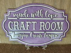 a purple sign that says made with love craft room imagine create inspire on the wall