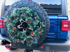 a christmas wreath on the back of a blue truck