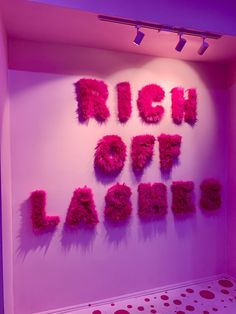 a pink room with the words rich out lager written in bright letters on it