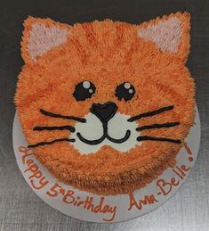 a birthday cake with an orange cat face