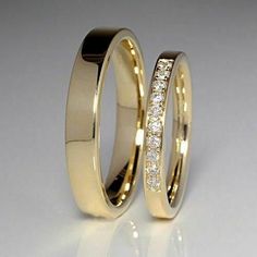 two yellow gold wedding rings with diamonds on each one and the other in between them