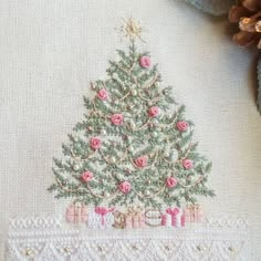 a cross stitch christmas tree with pink roses