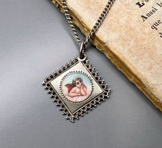 A beautiful genuine vintage Guardian angel medal, petite enamel 800 silver, German religious lucky charm, fairly rare Guardian angel charm, hallmarked, in good vintage condition. Ideal for protection necklace, would make a nice gift for someone special! Comes with 18-inch long vintage 925 silver necklace (see photo 3)! Material: solid silver  Total weight: 6.1g Measures: approx. 23 x 23 mm (0.9 x 0.9 inch)  PLEASE LOOK AT THE PICTURES, THEY ARE PART OF THE DESCRIPTION AND ARE THE ACTUAL ITEM YOU WILL RECEIVE. ALL OUR ITEMS ARE IN WORN, VINTAGE CONDITION. Antique Miraculous Medal Necklace As Gift, Vintage Handmade Medallion Charm Necklace, Vintage Handmade Medallion Charm Necklaces, Handmade Vintage Medallion Charm Necklaces, Silver Enamel Round Pendant Charm Necklace, Silver Enamel Charm Necklace With Round Pendant, Antique Silver Jewelry With Miraculous Medal, Antique Engraved Enamel Necklace, Vintage Charm Round Pendant Jewelry For Commemoration