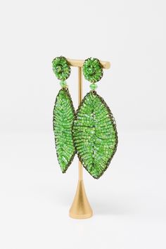 The Lavish by TM Green Leaf Earrings are beautiful addition to any outfit! Material: Enameled wire, hypoallergenic and nickel-freeOrigin: Hand made in Brazil Stud closure Hand crocheted Lightweight 3.5" drop Lavish by Tricia Milaneze is ethereal and lace designs are ideal for women looking for an attractive accessory, but avoiding solid, heavy jewelry. All pieces are extremely feminine, wearable and accessible. Elegant Green Hypoallergenic Beaded Earrings, Green Metal Beaded Earrings For Party, Green Metal Beaded Party Earrings, Heavy Jewelry, Lace Designs, Made In Brazil, Green Leaf, Lace Design, Leaf Earrings