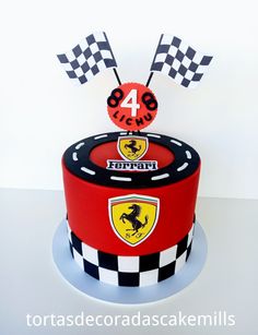 a red and black cake with the number four on it's top is decorated like a race car