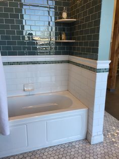 a bath tub sitting under a window in a bathroom