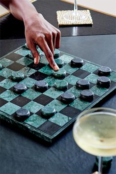 a person is playing checkers on a board game