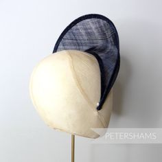 The shape of this season (and next's) has arrived! Halo crowns have stormed the millinery world and are the perfect step up from a chunky headband for a special occasion. Made from a double layer of high-quality stiffened french navy sinamay, this shape has a domed front with a hollow underside, sinamay bias finished edges and tapered ends that sit nicely at the side of the head. You will need to fit a headband to this shape to make it functional, and our 5mm satin covered headbands do the job p Fitted Summer Headpiece With Structured Crown, Kentucky Derby Adjustable Headpiece With Structured Crown, Adjustable Curved Brim Headpiece For Races, Adjustable Pinched Crown Summer Headband, Adjustable Pinched Crown Headband For Summer, Adjustable Structured Crown Headpiece For Summer, Adjustable Structured Crown Costume Hats For Royal Ascot, Adjustable Headband With Structured Crown For Summer, Adjustable Brimmed Headpiece For Races