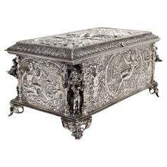 an ornate silver box is shown on a white background