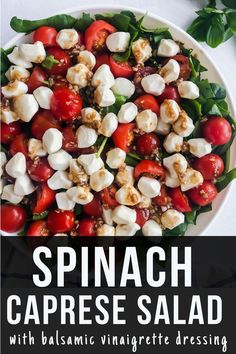 spinach caprese salad with balsamic vinaigrete dressing in a white bowl