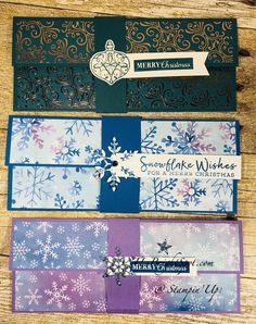 three christmas cards with snowflakes on them, one is blue and the other is purple