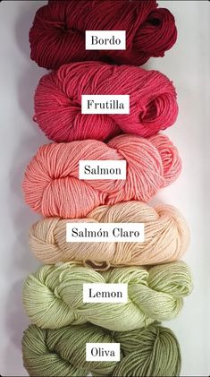 four skeins of yarn in different colors and sizes, with the names on each skein