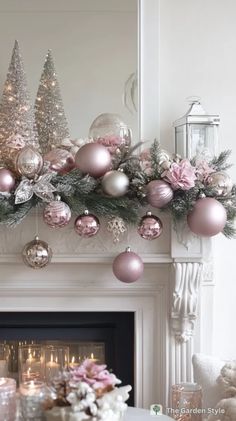 a fireplace mantel decorated with pink and silver ornaments