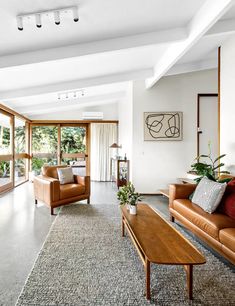 a living room filled with furniture and lots of windows