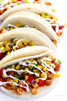 several tacos are lined up on a plate