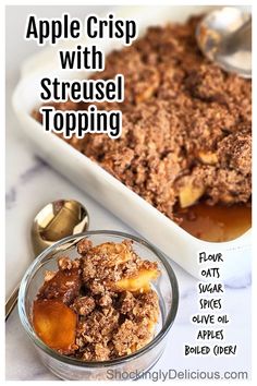 an apple crisp with streusel topping in a glass bowl next to spoons