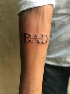 a man's arm with the word dad tattooed on it