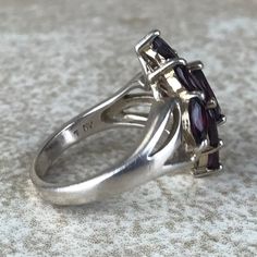 Garnet Cluster Ring Sz 7/Sterling Silver/Genuine 5.4ct Marquise Cut/Rhodolite Garnet/Signed/Pink Purple Garnet/Vintage Estate/Ring For Women Description Beautiful rhodolite garnet ring in excellent vintage condition. A total of 5.4ct of genuine, marquise cut garnet set in designer signed stamped 925 sterling silver setting. Face of ring measures 20mm from top to bottom and has a weight of 5.1g. Gorgeous pink purple color and fantastic sparkle! Size 7. All Gems tested with Presidium Gem Tester. A Purple Garnet, Garnet Ring Vintage, Garnet Wedding, Rhodolite Garnet Ring, Star Garnet, Estate Ring, Garnet Gem, Estate Rings, Garnet Ring