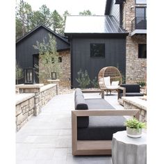 an outdoor living area with couches and chairs