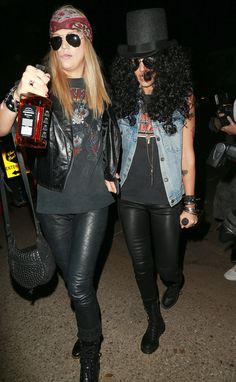 two women in leather pants and hats are walking together