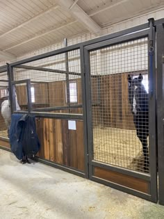 two horses are in their stalls at the stable