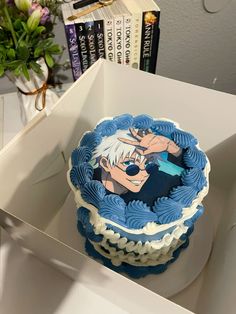 a blue and white cake sitting on top of a table